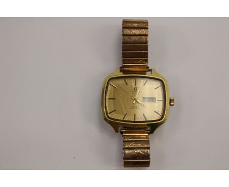  A gentleman's Tissot Seven Automatic bracelet watch, having gold rectagular dial with raised batons, day and date apertures,