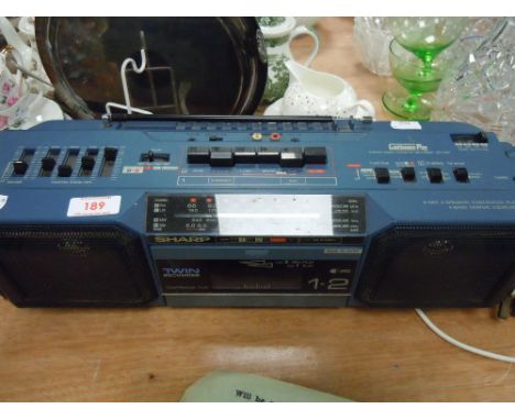 A Sharp stereo radio cassette recorder with twin mechanism.