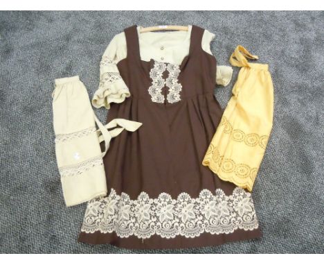 A vintage ladies dirndl dress and blouse and two similar styled aprons,around 1960s.