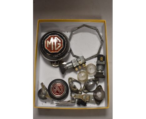 A selection of MG parts to include badges, number plate light fittings,switches and more.