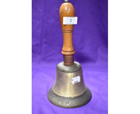 A vintage wooden handled ARP hand bell, body appears to have been polished, possibly to remove an inscription.