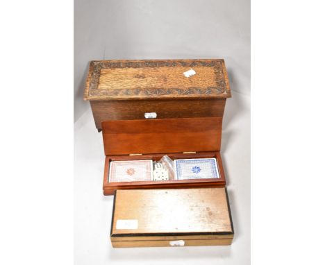 Two vintage boxes, one of carved oak in the form of a kist, also included is a boxed set of playing cards.