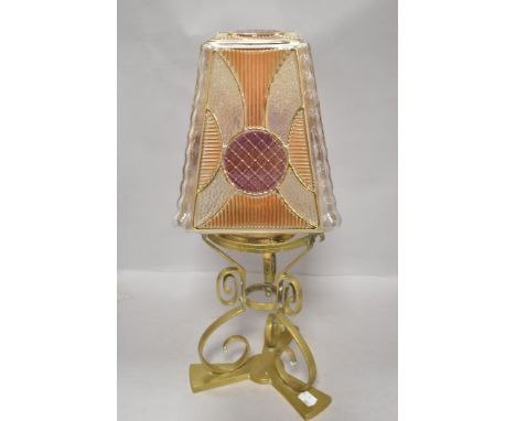 A Victorian Arts and Crafts oil lamp stand in brass with pressed glass shade in orange and purple