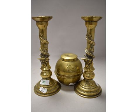 A 1924 dated brass Lipton souvenir tea caddy and a pair of brass candlesticks having dragon or serpent design to stems.