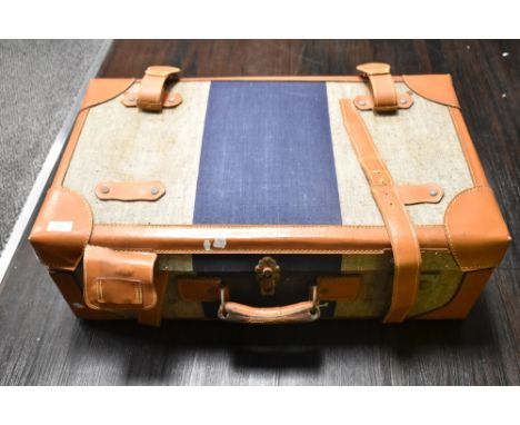 A vintage style suitcase, tweed style and leather finish