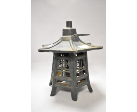 A modern cast metal Pagoda styled lamp or tea light holder.