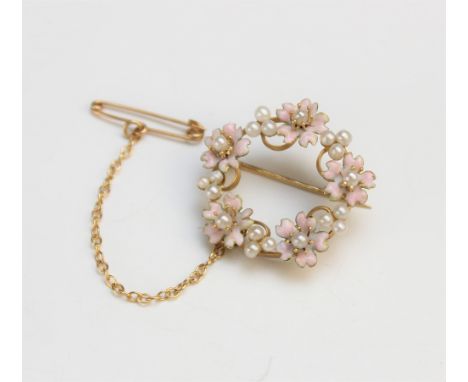 A French 18ct gold enamel and seed pearl set wreath form brooch, early 20th century, designed as five pink enamelled flower h