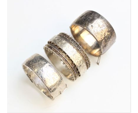 A Victorian silver hinged bangle, half decorated with beaded and chased floral detailing, marks for Robert James Dick, Birmin