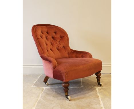 A Victorian walnut and upholstered balloon back nursing chair, the button back above a spring serpentine seat, raised upon kn