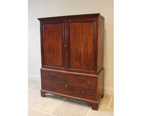 A 19th century mahogany linen press, the moulded cornice above a pair of panelled doors enclosing five oak sliding trays each