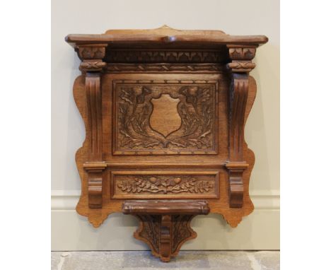 A carved oak wall bracket, 20th century, carved with a vacant shield and thistles, 55cm high 