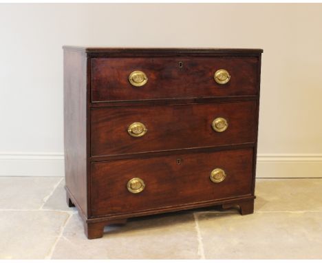 An early 19th century mahogany chest of drawers, formed as three drawers set with oval brass handles, raised on bracket feet,