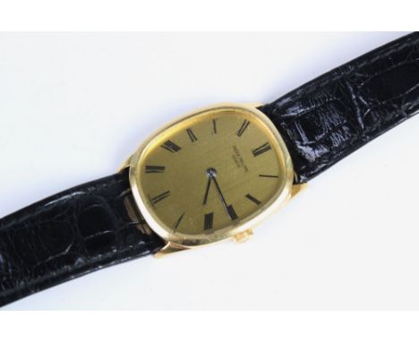 A Gentleman's 18ct gold Patek Phillipe Ellipse wristwatch, the gold-toned dial with Roman numerals, set to a plain polished 1