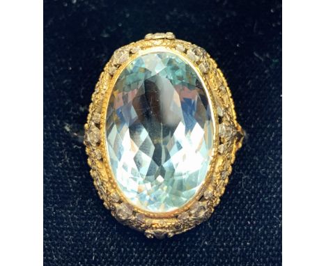 An aquamarine ring, the central oval mixed cut light blue aquamarine measuring approximately 23.5mm x 15.5mm x 10.4mm, within
