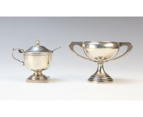 An Art Deco miniature silver twin-handled trophy by Emile Viner, Sheffield 1934, of compressed form on stepped circular foot,