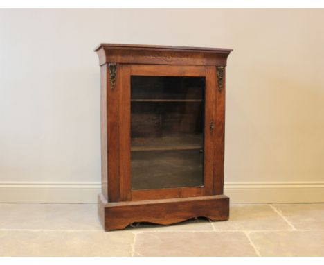 A Victorian walnut pier cabinet, with foliate inlaid motif above a single glazed door, enclosing two shelves, raised on plint