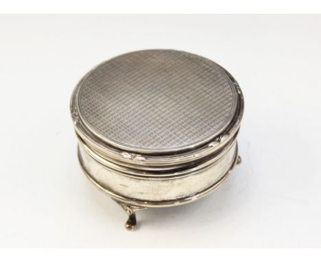 A George V silver jewellery box by Walker &amp; Hall, Sheffield 1926, of circular form on three raised feet, the hinged cover