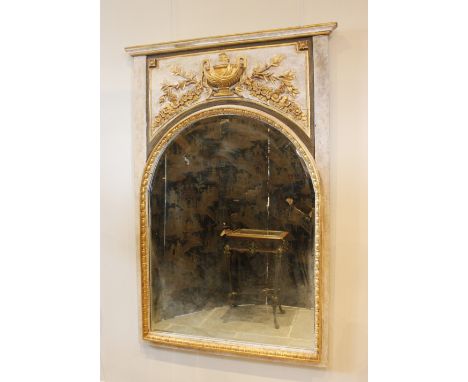 A French Neo-classical style pier mirror, with arched bevelled mirror plate below a gilt relief urn terminating with floral g