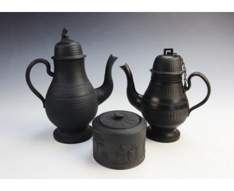 A black basalt coffee pot and cover, early 19th century, the body with incised ozier decoration, the domed cover with Sybil (