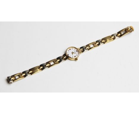 A lady's 9ct gold Rotary wristwatch, the round white dial with Roman numerals and baton markers, set to a plain polished circ