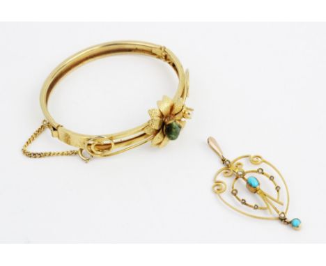 An Edwardian turquoise and pearl set 9ct gold pendant, comprising a central turquoise cabochon and eight small seed pearls se