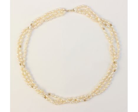 A three-strand pearl necklace, comprising three rows of ridged cultured pearls, interspersed with spherical yellow metal bead