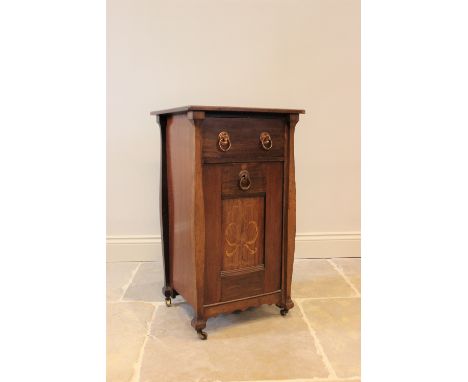 An early 20th century Art Nouveau mahogany coal purdonium, the rectangular top above a single drawer and fall front, centred 