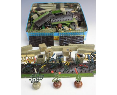 A collection of Britains Ltd miniature garden pieces, circa 1930s, to include flower beds, fence and trellis panels, crazy pa