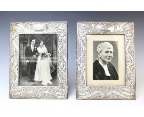 A pair of Art Nouveau silver mounted photograph frames by J & R Griffin, Chester 1905, each of rectangular form with embossed
