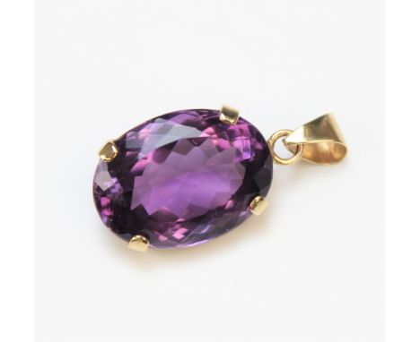 An amethyst set pendant, the oval mixed cut amethyst (measuring 20mm x 14mm) within a four claw 9ct yellow gold setting, with