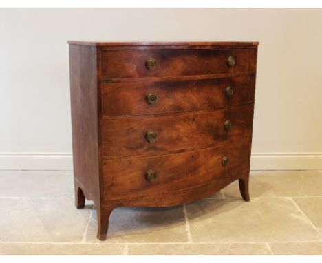 An early 19th century bow front mahogany chest, of four graduated long drawers, each applied with gilt metal ring handles, ra