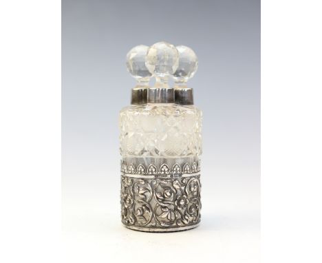 An Edwardian silver mounted set of three cut glass scent bottles and stoppers by Collyer & Co, Birmingham 1904, decorated wit
