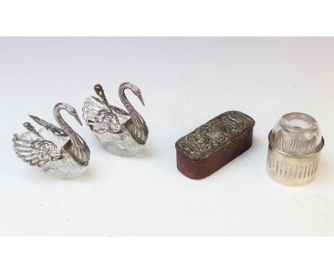 A pair of Continental cut glass and white metal mounted salts in the form of swans, each with pierced articulated wings with 