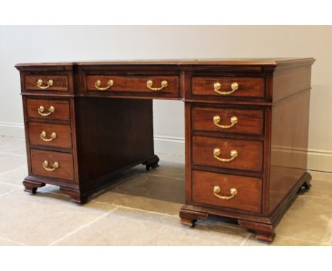 A 19th century mahogany inverted break-front pedestal desk, inset with a leather skiver above a central drawer flanked by two