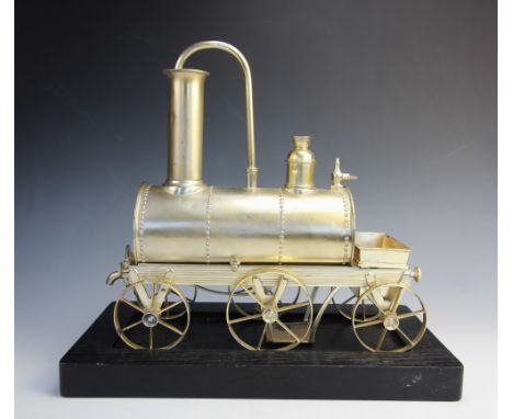 A white metal novelty coffee percolator, modelled as an early 19th century steam locomotive, with removable tender and boiler