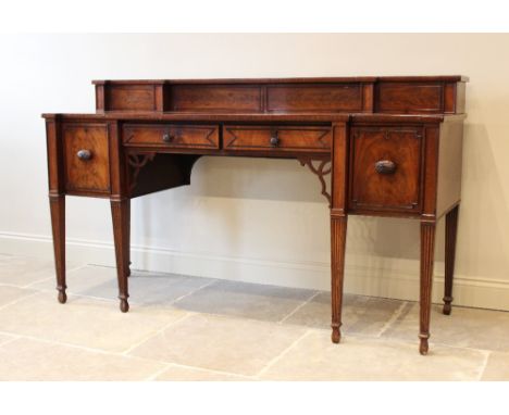 A Regency breakfront mahogany sideboard, the raised back with an open shelf over two central frieze drawers flanked by cupboa