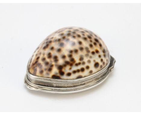 A 19th century white metal mounted cowrie shell snuff box, the hinged cover embossed with flora and fauna with vacant cartouc
