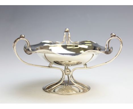 An Art Nouveau silver tazza by Hukin & Heath, Birmingham 1906,of circular form with shaped rim with three scroll handles, 8.2