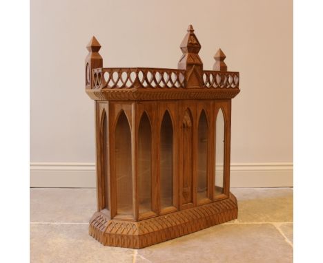 A carved oak Gothic revival wall hanging display cabinet and bracket, 20th century, with six arched glazed panels, 85cm H x 7