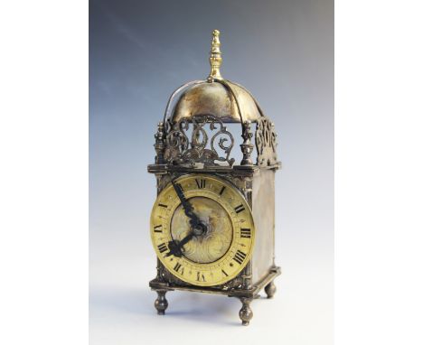 A 17th century style French brass lantern clock, early 20th century, the strapped bell above a 10cm dial and spring driven mo