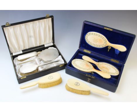A cased set of carved ivory brushes and a mirror, each piece with intricately carved frieze of roses and foliage, monogrammed