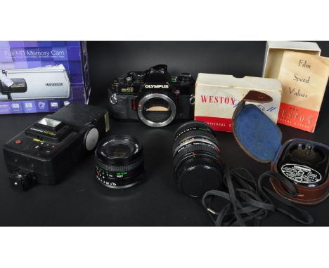 An assortment of three vintage 20th century cameras &amp; related equipment. The lot to include an Olympus OM40 Program camer