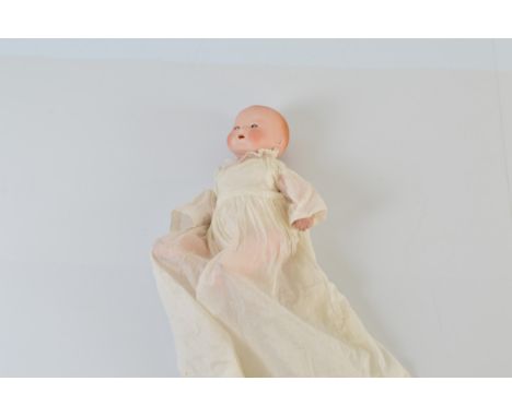 An Armand Marseille bisque head baby doll, with sleeping eyes. Stamped AM Germany 351/3 1/2 K to back of neck