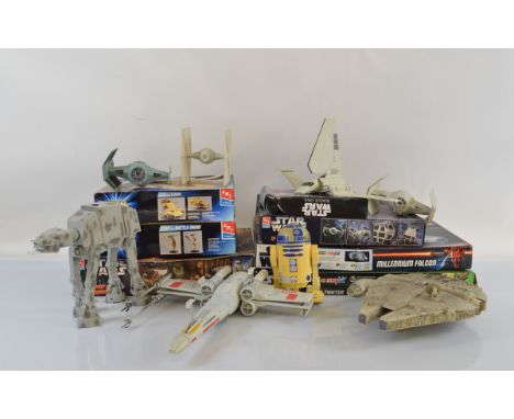 A collection of Star Wars related model kits and vehicles, including AMT Ertl and Revell, mostly started