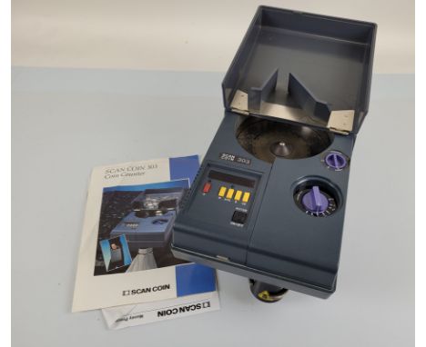 A contemporary scan coin counter, model 303, with boxes and instructions