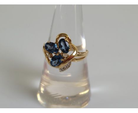 A contemporary 14ct gold topaz and diamond dress ring, floral setting in yellow gold, marked 585 to shank, 14k, ring size Q, 