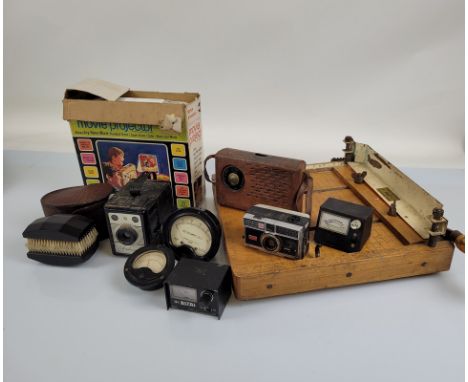 A mixed lot, including an ebonised brush set contained in a crocodile skin case, amp meters, cameras, guillotine, movie proje