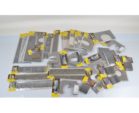 Forty Faller HO and N gauge model railway layout accessories, including road foils, tunnel portals etc, all bagged.