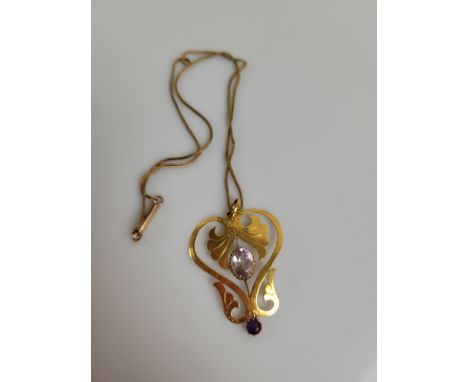 A 9ct gold Art Nouveau amethyst drop pendant, the flattened open work with leaf design mixed cut oval amethysts with circular