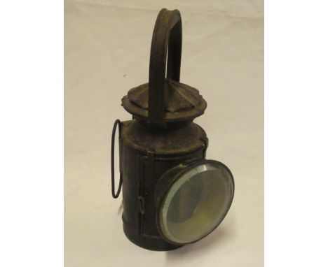 A painted metal railway hand lantern with internal oil lamp fitment
